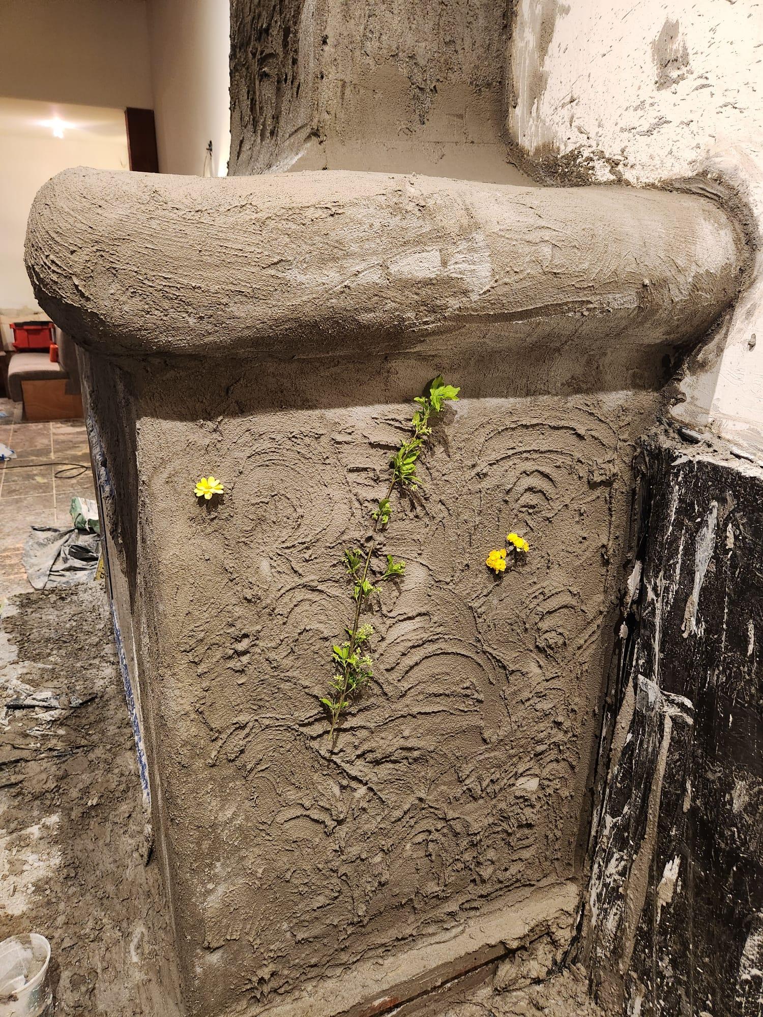 Botanical elements used to imprint a hand-shaped fireplace texture