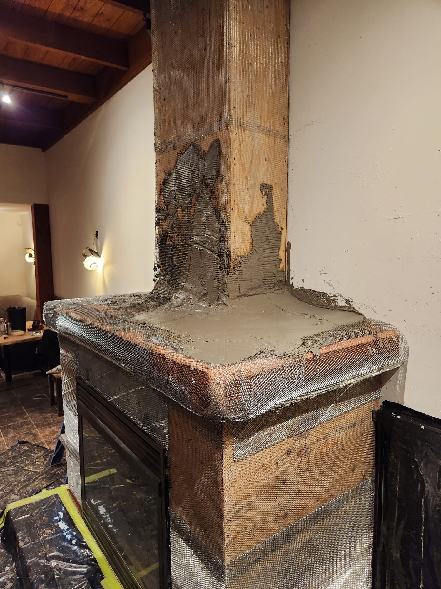 First mineral base layer being applied over the fireplace mesh