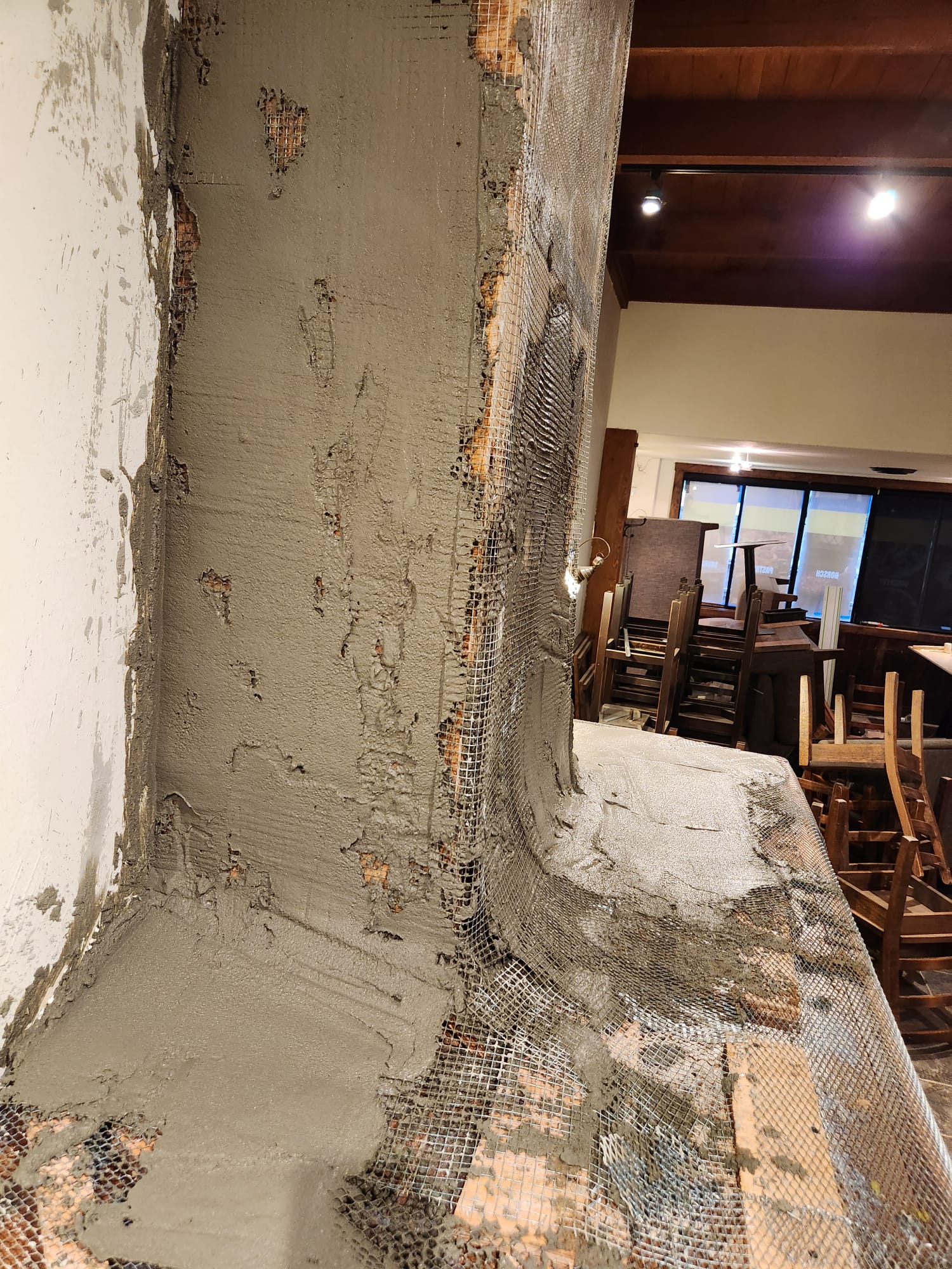 Mineral material being built up to shape the fireplace profile