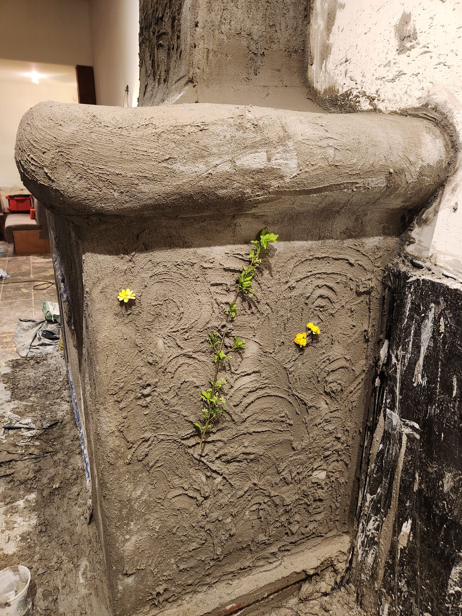 Botanical elements used to imprint a hand-shaped fireplace texture