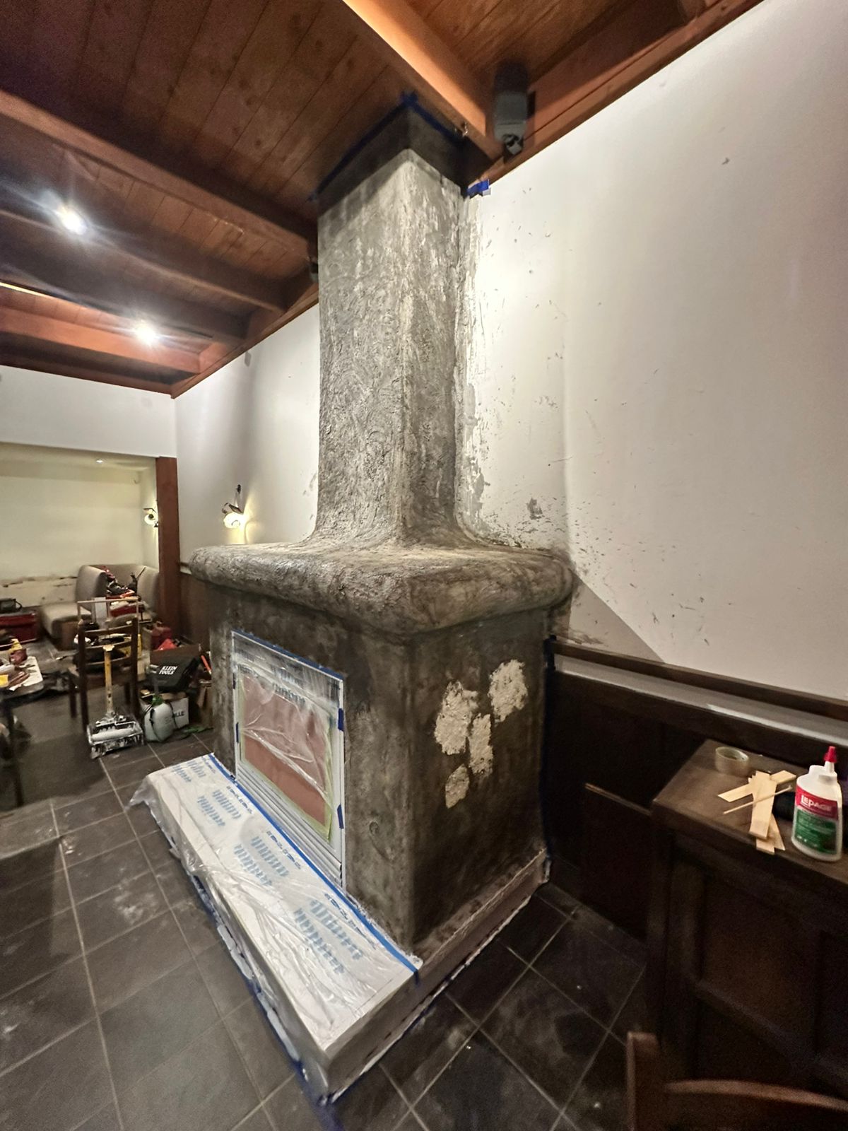 Textured restaurant fireplace during surface refinement before painting