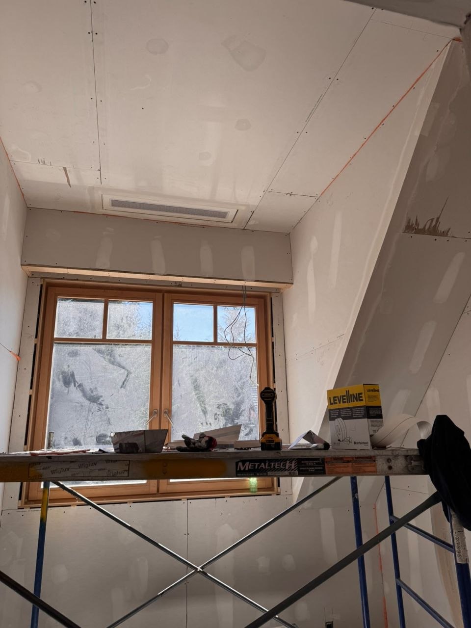 Interior walls and sloped ceiling prepared for painting in a private Whistler residence